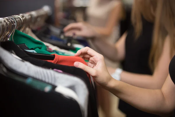 Woman choosing clothes on rack, closeup — Stockfoto