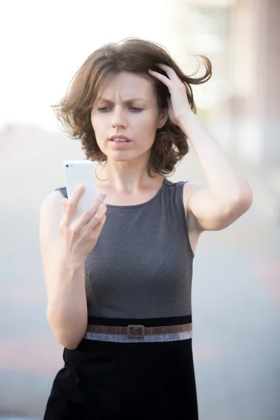 Young woman upset by phone call — Stock Photo, Image