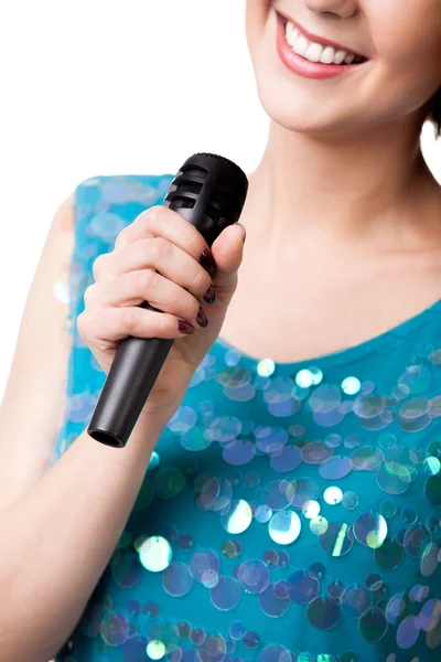 Smiling young woman holding microphone, close up — Stock Photo, Image