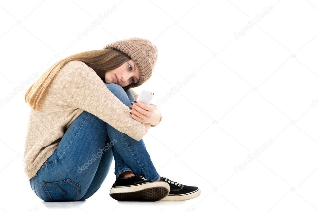 Teenage girl waiting for call with smartphone in her hands