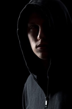 Portrait of mysterious man in the dark clipart