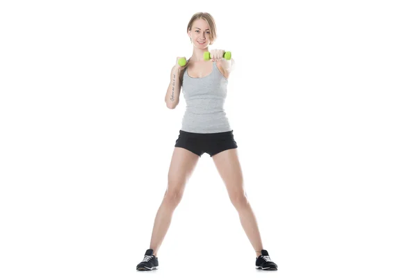 Sporty woman doing dumbbell training — Stock fotografie