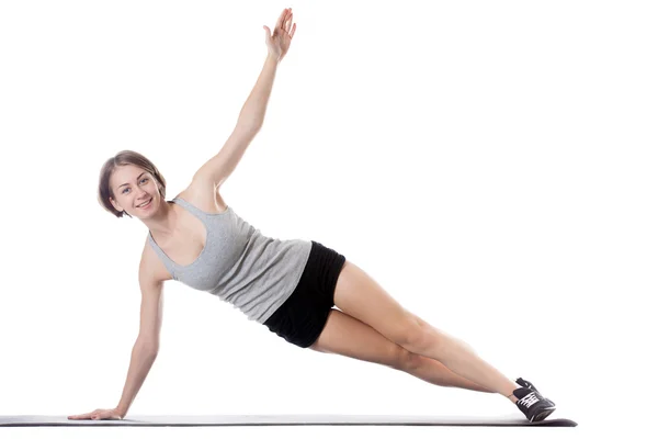 Sporty woman doing side plank exercise Royalty Free Stock Photos