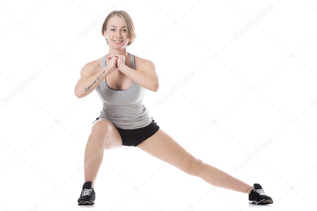 Sporty woman doing side lunges