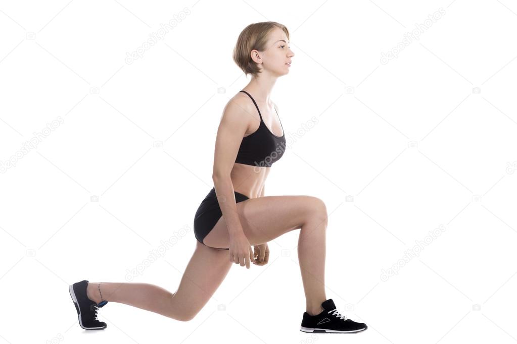 Sporty woman doing low lunges