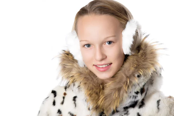 Girl in furry coat and earmuffs — Stockfoto