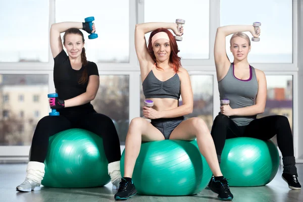 Exercising with dumbbells on fitballs — Stock Photo, Image