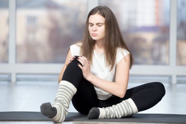 Woman injured her knee during sport exercise