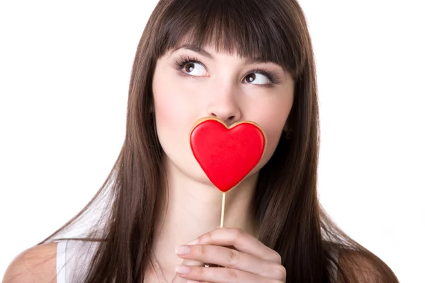 Happy woman in love holding heart shaped biscuit — Stock Photo, Image