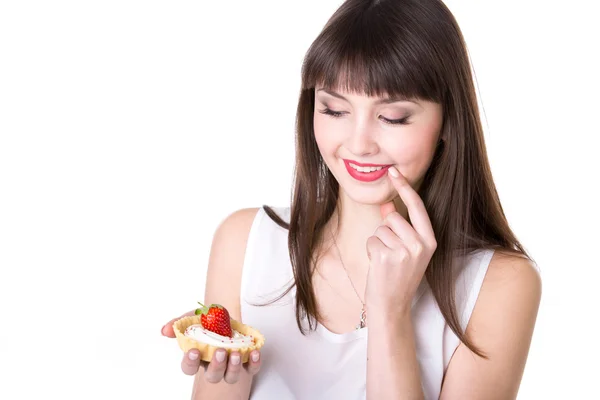 Young woman deciding to eat cake — Stockfoto