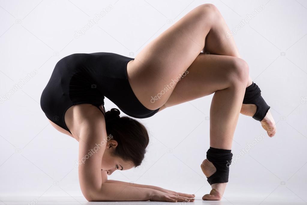 Young woman doing acrobatic exercise