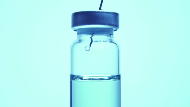 Medical vaccine scientist work in laboratory and developing research of vaccine against Coronavirus, COVID-19, MERS, 2019-ncov. Mixing blue liquid in glass vial with needle. Evaluation and trials.
