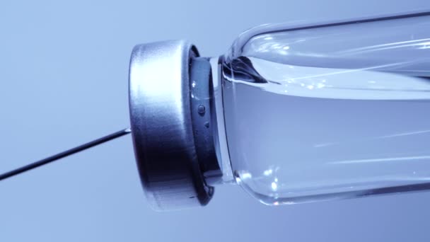 Macro close up of administration vaccine or medication with syringe and vaccine vial at the hospital. Health and medical concepts. Filling syringe from glass bottle. — Stock Video