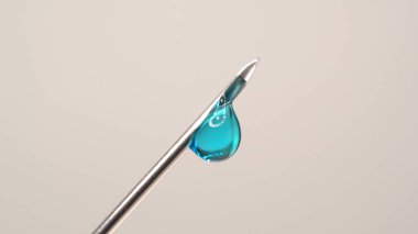 Steril şırınga iğnesinden damlayan aşı makroyu kapat. Tıbbi iğne şırıngası ve hasta aşısı için şırınga ve aşı tedavisi uyguluyor. Sağlık kavramları.