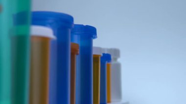 Çeşitli ilaç şişeleri makro yakın çekim. İlaç şişelerinin üretimi. İlaç sektörü, ilaç endüstrisi, ilaç ve uyuşturucu üretimi. Tıbbi araştırma ve deneyler.