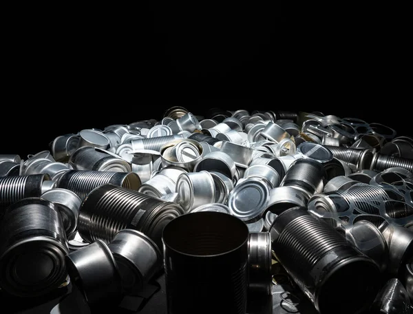 Metal tins, cans and jar garbage from household on the table. City home trash made of aluminum. Empty used, food and drink steel packaging waste and scrap discarded sorted and ready to recycle.