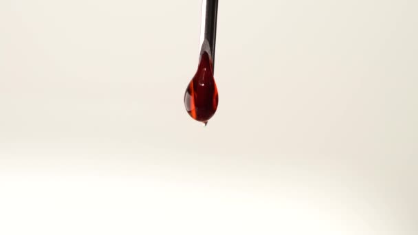 Drops of blood from the tip of the medical syringe. Bloody liquid dripping from needle, macro close up. Addiction horror illustration. Used syringe needle in blood. Administration of street drugs. — Stock Video