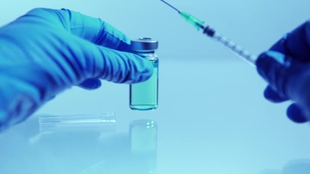 Macro close up of administration vaccine or medication with syringe and vaccine vial at the hospital. Health and medical concepts. Filling syringe from glass bottle. — Stock Video