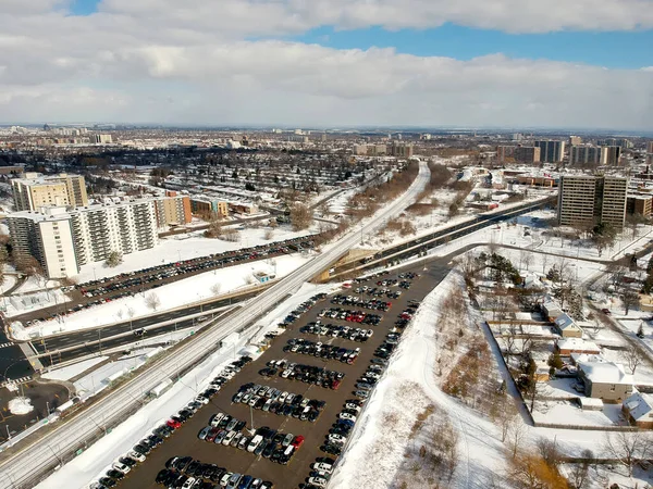 Aerial bird eye view skyline at Winter season in Canada. Hundreds of low and high rise houses from top view in the background covered in high level of snow.