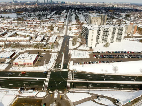 Aerial bird eye view skyline at Winter season in Canada. Hundreds of low and high rise houses from top view in the background covered in high level of snow.