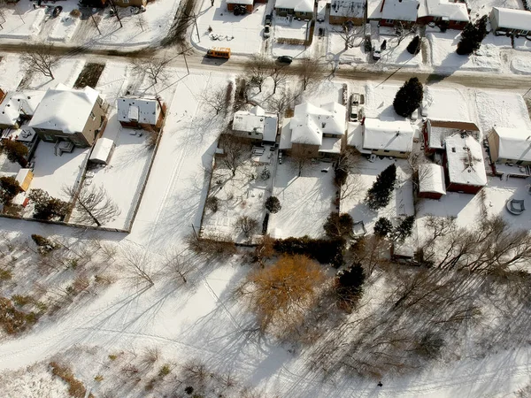 Snow view from the top with urban city, aerial photography over the suburb. Winter scenery of the American city from the bird eye.