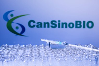 Toronto, Ontario, Canada - February 14, 2021 : CanSino Biologics Chinese vaccine vial with sterile needle syringe. Medical research against coronavirus, COVID 19. Drugs and medications. clipart