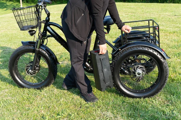 Woman Holding Battery Pack Electric Bicycle Her Bike Female Taking — Fotografia de Stock