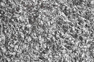 Silver wrinkled and shrunken foil surface