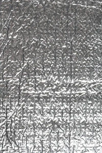 Silver wrinkled and shrunken foil surface — Stockfoto