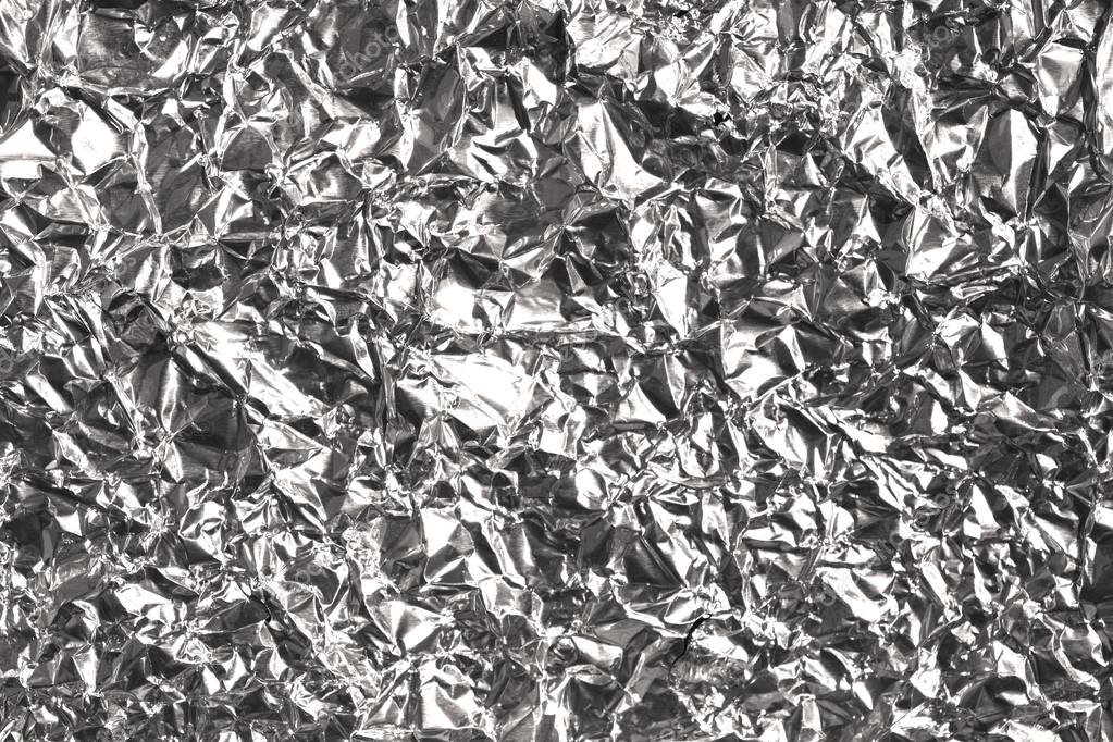 Silver wrinkled and shrunken foil surface