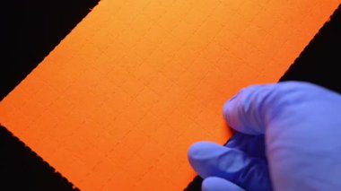 LSD Psychedelics terapisi ve Lysergic asit deneyleri. Halüsinojenik ilaç oral tüketim ve akıl sağlığı. LSD 'li adam kendini tedavi ederken kuru liserjik asit damlaları ile şeritleri tutuyor..