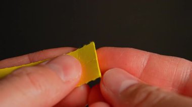 Partideki ya da dans kulübündeki kişinin elleri, LSD şeritlerini, tüketim için kullanılabilecek halüsinojenik ilaç Lucy ya da Ellis D. ile kuru bir Lysergic asit damlasıyla parçalayabilir ya da parçalayabilir..