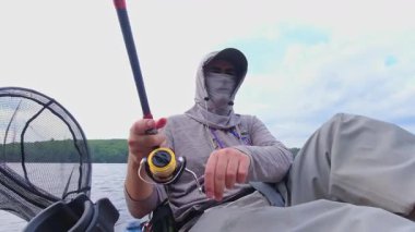 Kano sporu balıkçılığı. Angler kanoyla sahili gezmeyi seviyor, oltasını atıp sersemletiyor. Huzurlu su kıyısı ve Simcoe Gölü, Ontario, Kanada 'da mükemmel bir ortam. Yakala ve bırak..