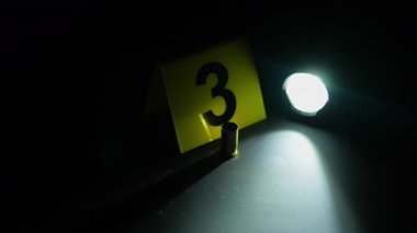 Siyah gece kulübü zemininde mermi kovanı var. Ateşli silah konseptiyle toplu katliam. Sarı delil işaretleriyle soruşturma için Olay Yeri İnceleme yasak bölgesi.