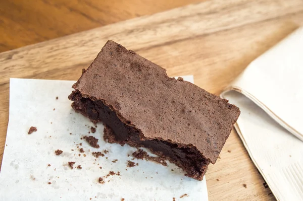 Bitten delicious Chocolate Brownie on wooden tray — Stock Photo, Image