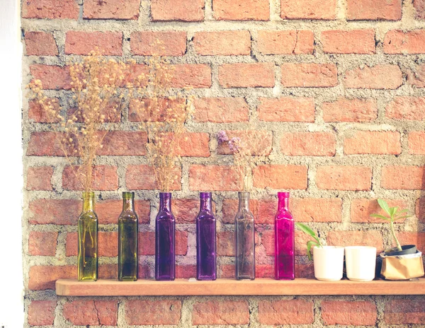 Colorful glass bottle on wooden shelf — Stock Photo, Image
