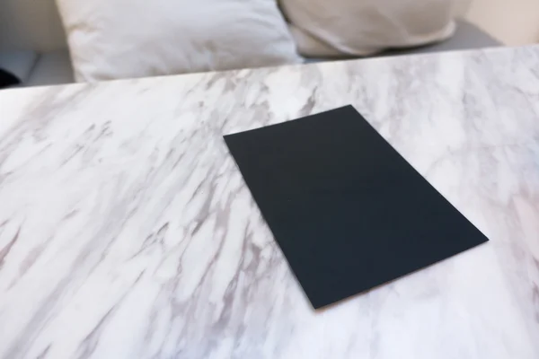 Papel negro sobre mesa de mable — Foto de Stock