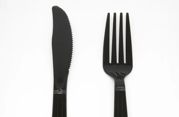 Tenedor y cuchillo de plástico negro — Foto de Stock