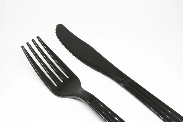 Black plastic fork and knife — Stock Photo, Image