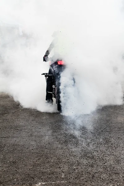 特技骑自行车的人燃烧轮胎与烟雾 — 图库照片