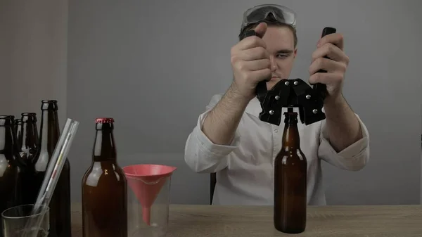 a young brewer prepares products and checks the quality of the equipment and the quality of honey beer brewed at home