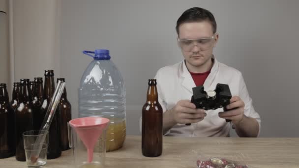 Young Brewer Dressed White Coat Transparent Goggles Closes Finished Beer — Stock Video