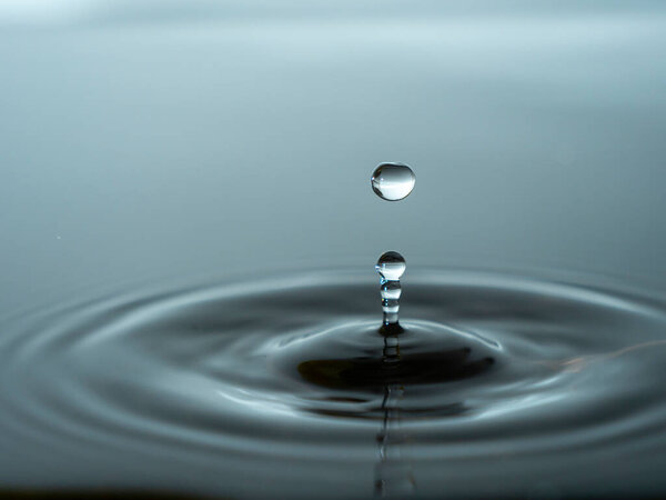 Splashing a drop of water into the aquarium. Colorful water drop