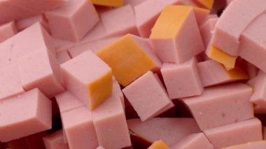 Boiled sausage, cutting and preparing sausages for kneading into Olivier salad, the concept of preparing a salad, food from the restaurant