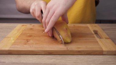 Boiled potatoes, cutting and preparing potatoes for kneading into Olivier salad, the concept of preparing a salad, food from the restaurant
