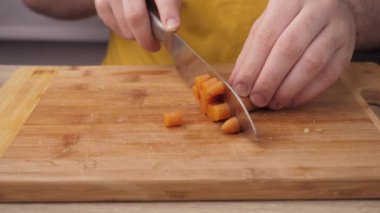 Boiled carrots slicing and preparing carrots for making Olivier salad, salad preparation concept, food from the restaurant
