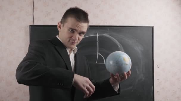 Teacher Black Suit Holds Globe His Hands Shows Draws Core — Stock Video