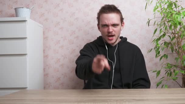 Young Guy Speaks Camera Dressed Black Tracksuit Sits Table Concept — Vídeos de Stock