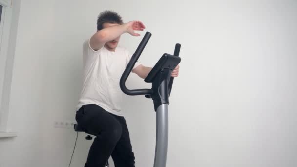 Young Sporty Handsome Guy Doing Sports Home Sitting Stationary Bike — Stock Video