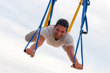 Fly Yoga, man doing yoga exercises on the sky background. Sport and healthy concept
